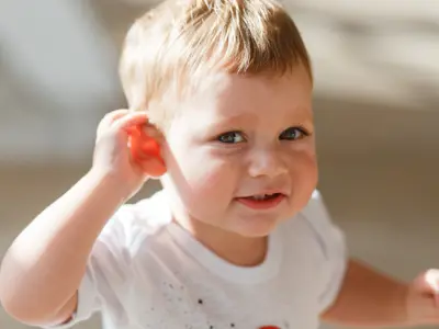 Infant holder his right ear